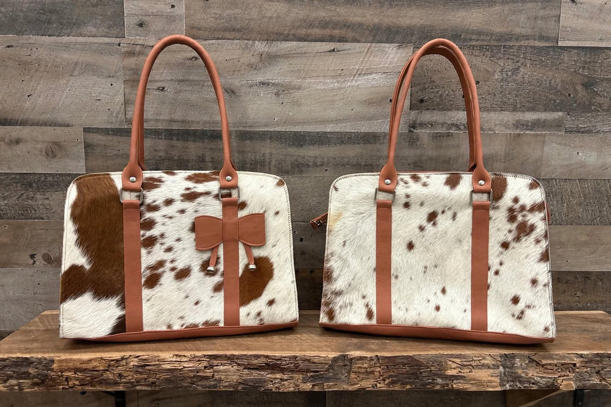 Leather purse with cowhide 14”L x 10”T 4” W adjustable shoulder strap included