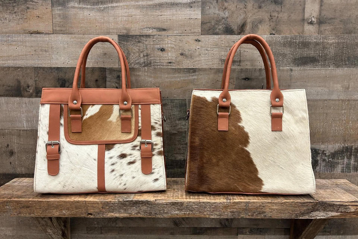 Leather purse with cowhide 14”L x 10”T 4” W adjustable shoulder strap included