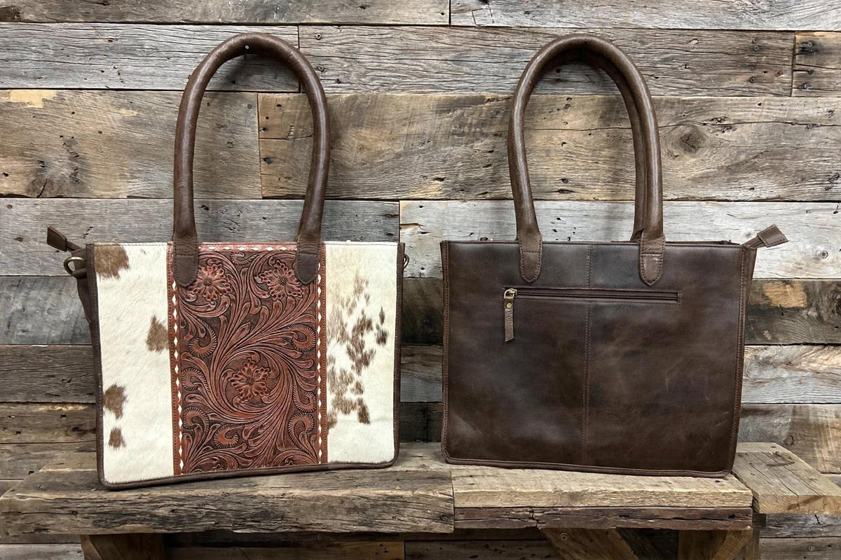 Leather purse with cowhide 14”L x 11”T x 3” W adjustable shoulder strap included