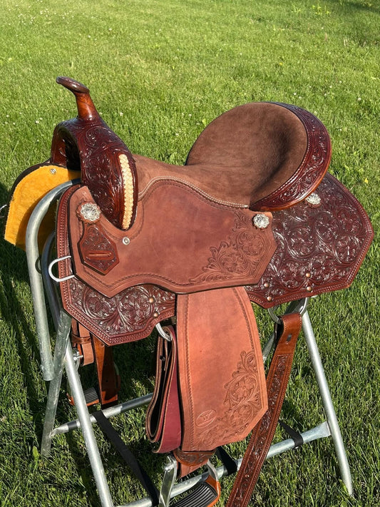 New 15” Western Saddlery floral tooled, braided rawhide,  padded seat, 7” gullet