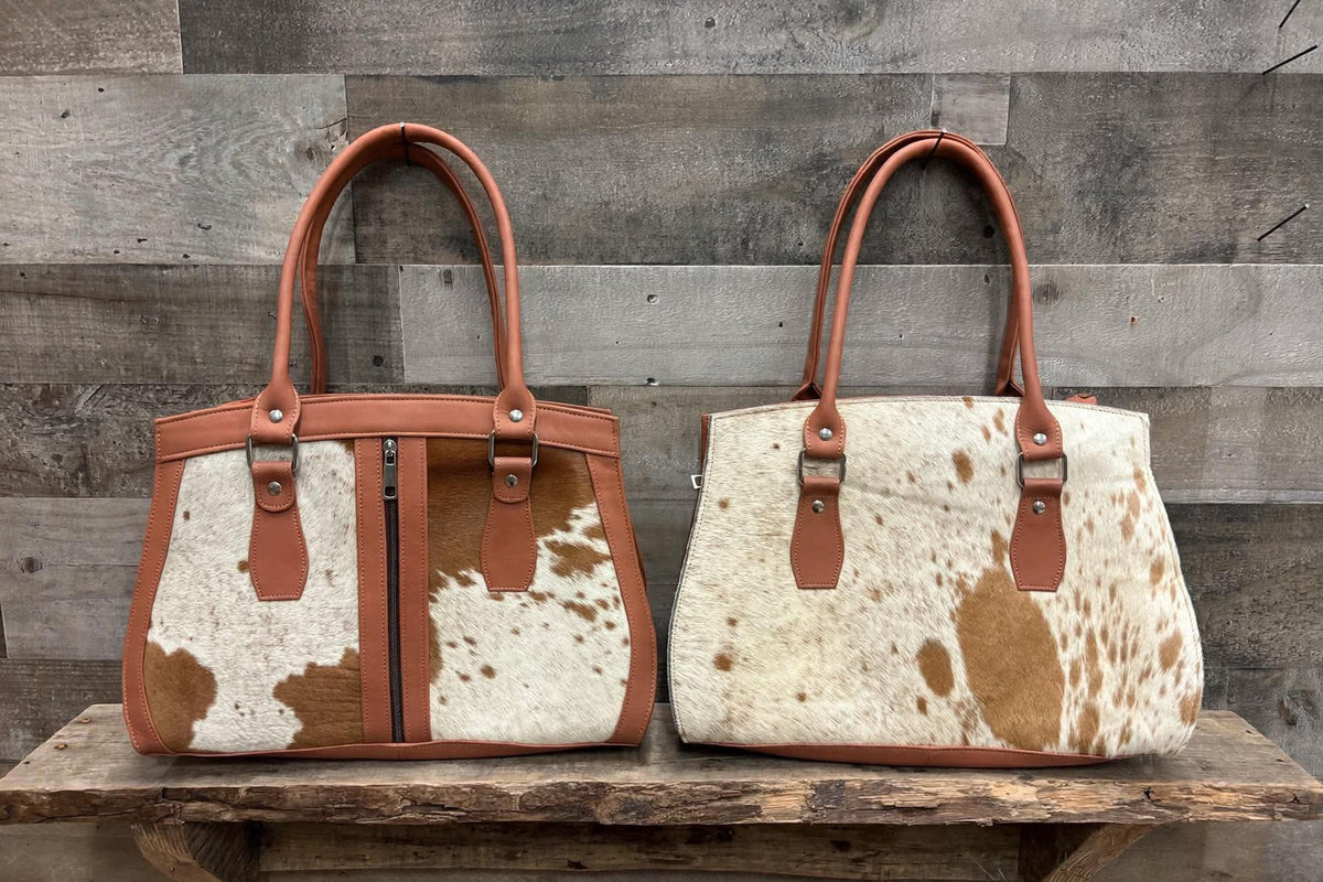 Leather purse with cowhide 14”L x 10”T 4” W adjustable shoulder strap included